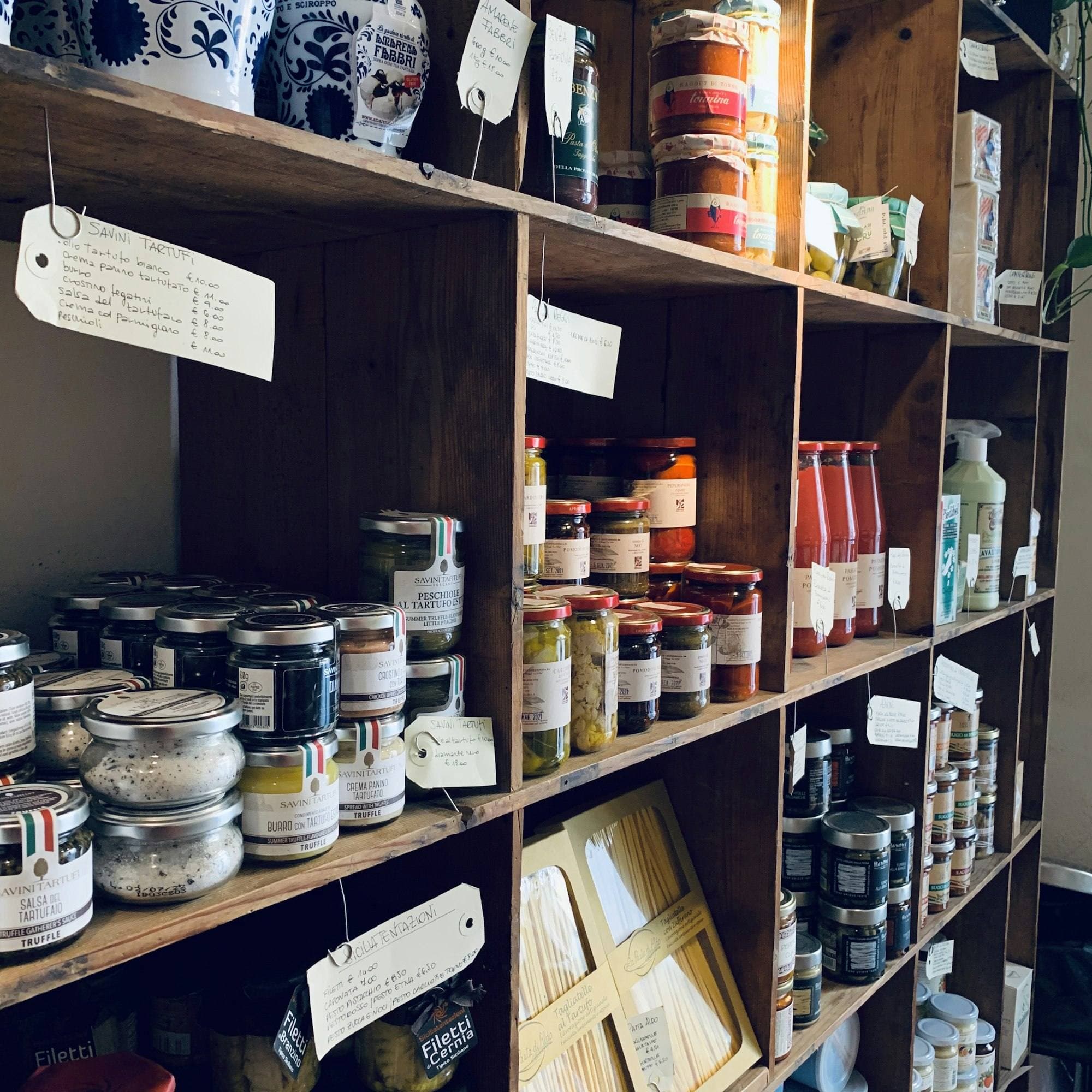 Wooden shelves with jars and tins in a small shop